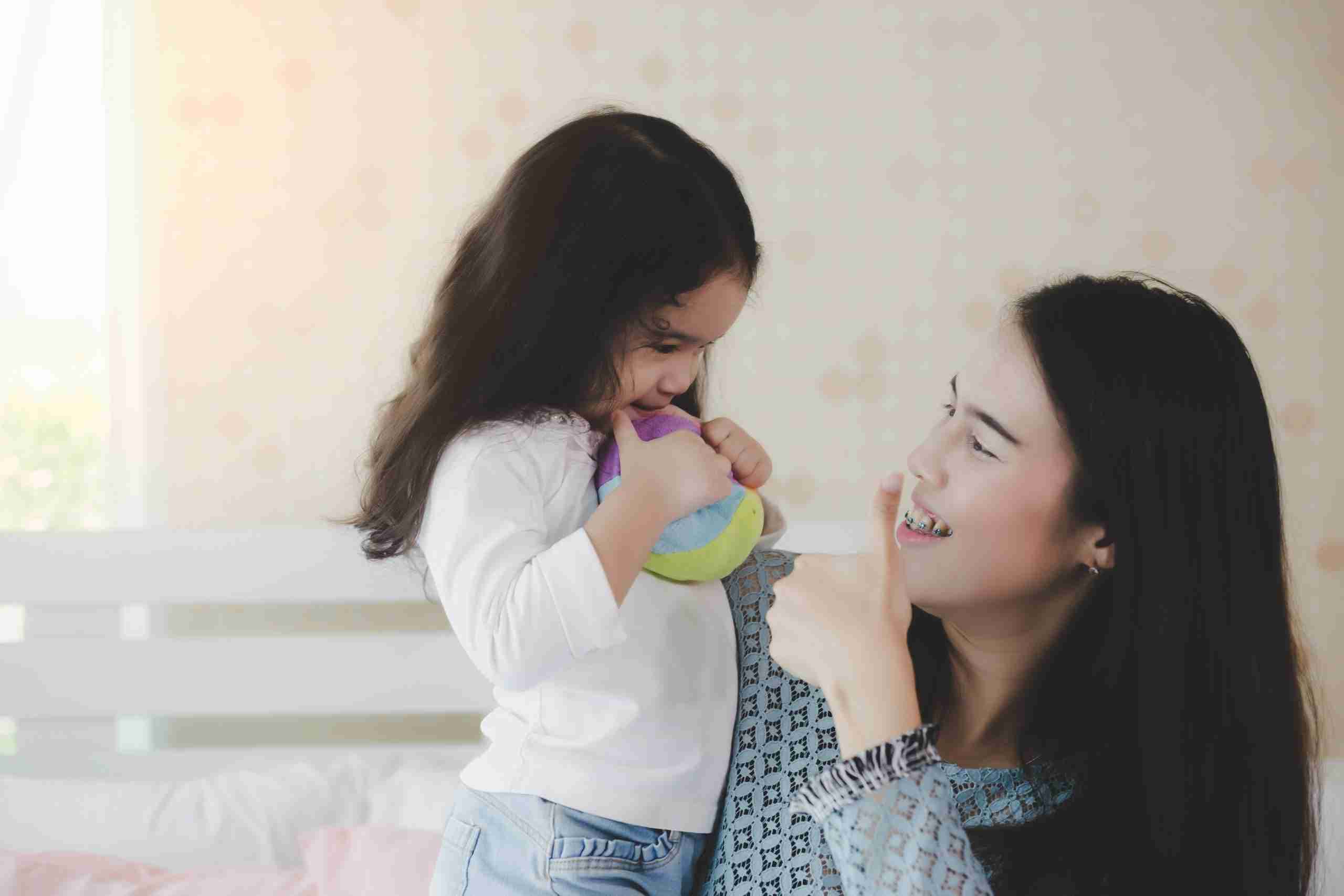 A parent gives a thumbs up to their child