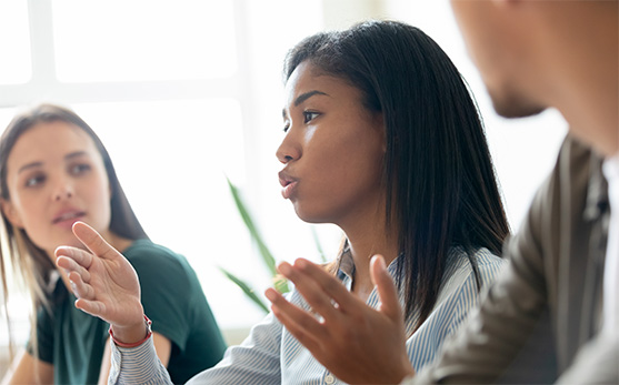 Three colleagues have a discussion