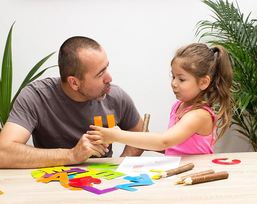 A speech language pathologist working with a young child.